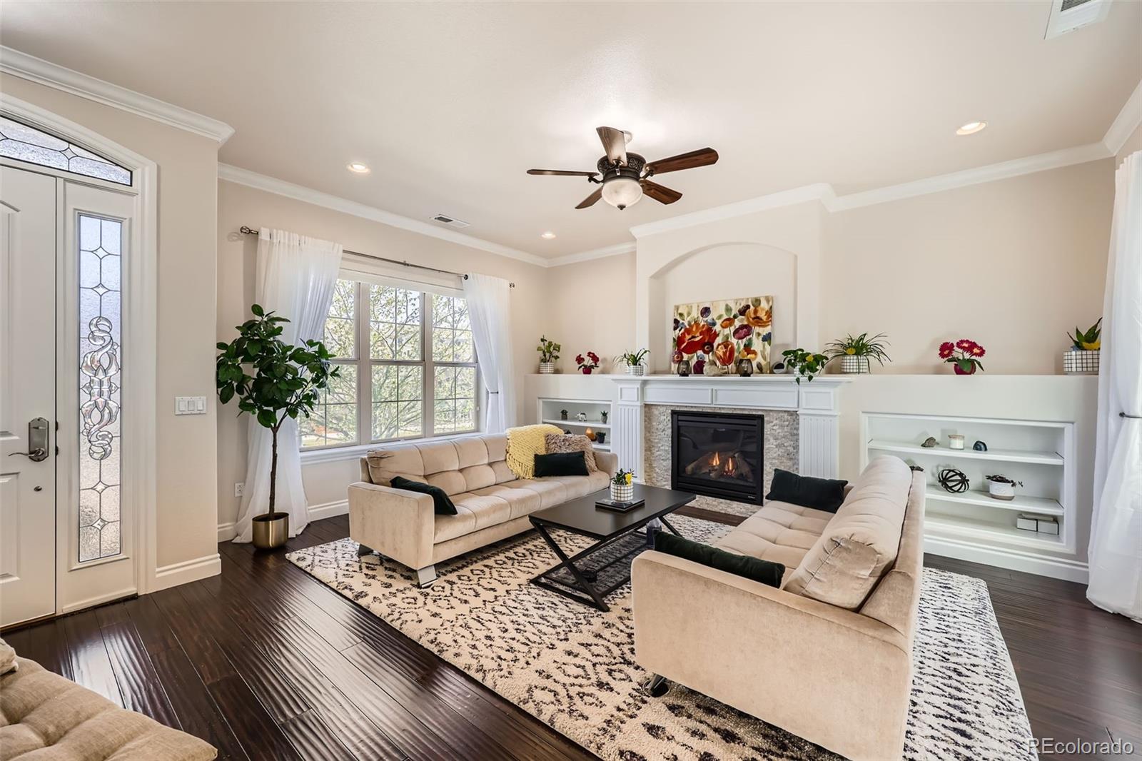 9182 Ridgegate Parkway Lone Tree, CO 80124 - Photo 4 of 31 a living room with furniture and a fireplace