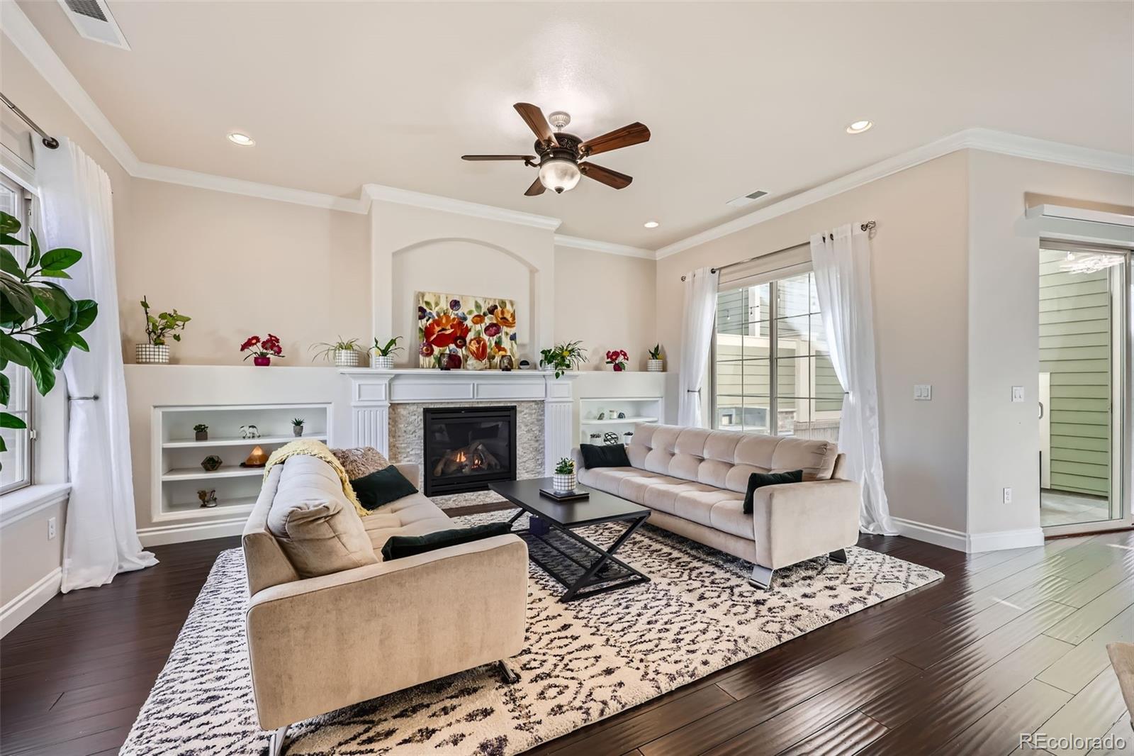 9182 Ridgegate Parkway Lone Tree, CO 80124 - Photo 5 of 31 a living room with furniture a fireplace and a window