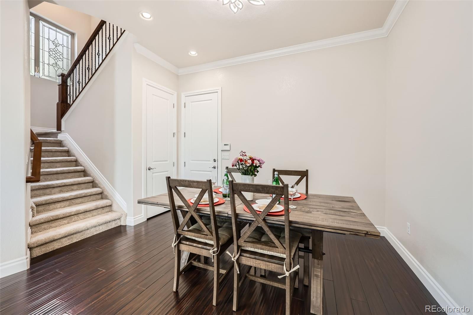 9182 Ridgegate Parkway Lone Tree, CO 80124 - Photo 8 of 31 a view of a dining room with furniture and wooden floor