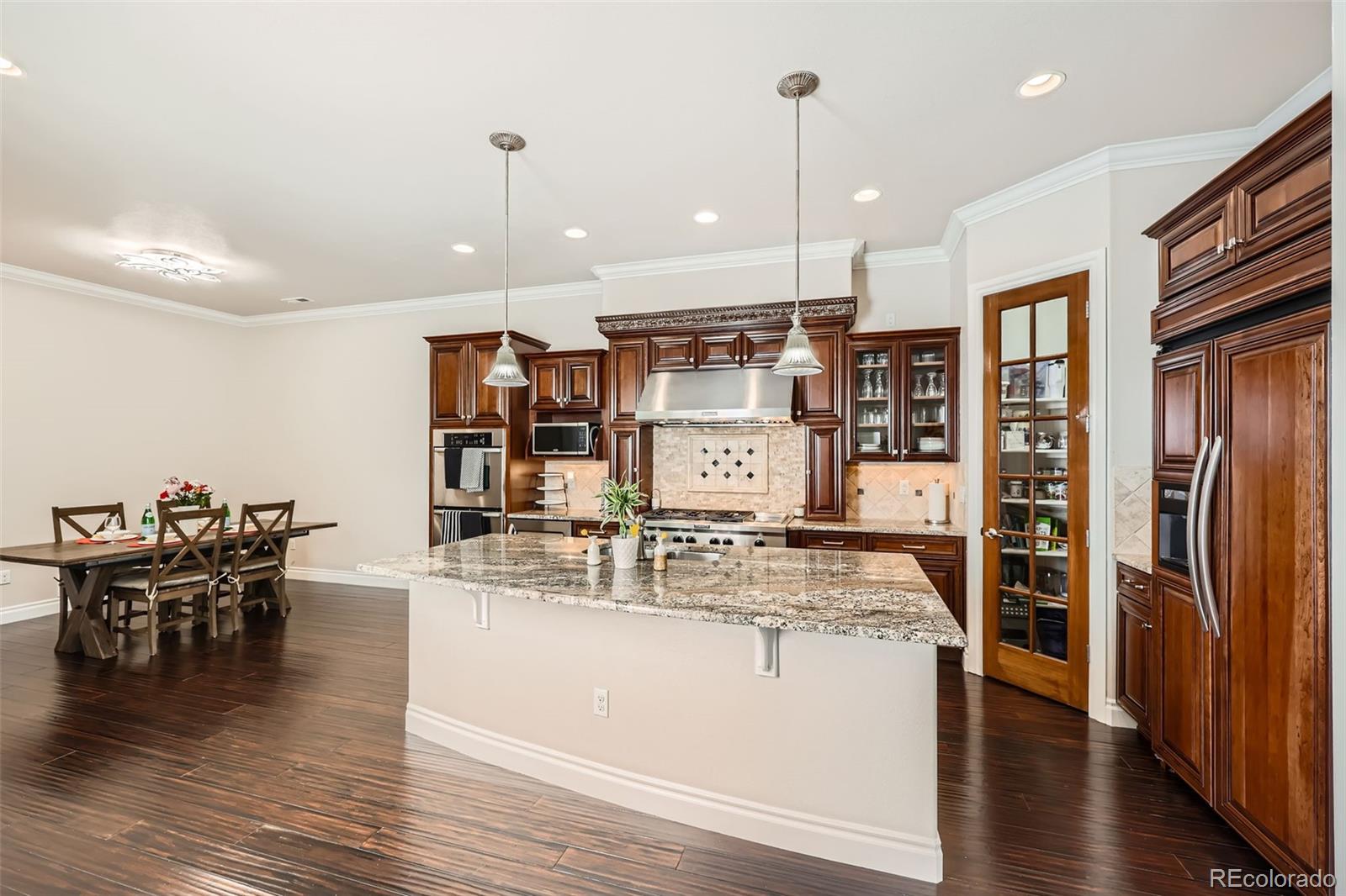 9182 Ridgegate Parkway Lone Tree, CO 80124 - Photo 10 of 31 a large kitchen with a table and chairs