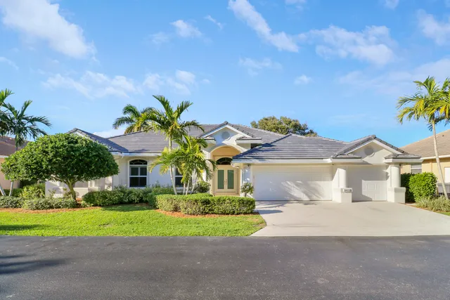 a front view of a house with a yard and outdoor seating