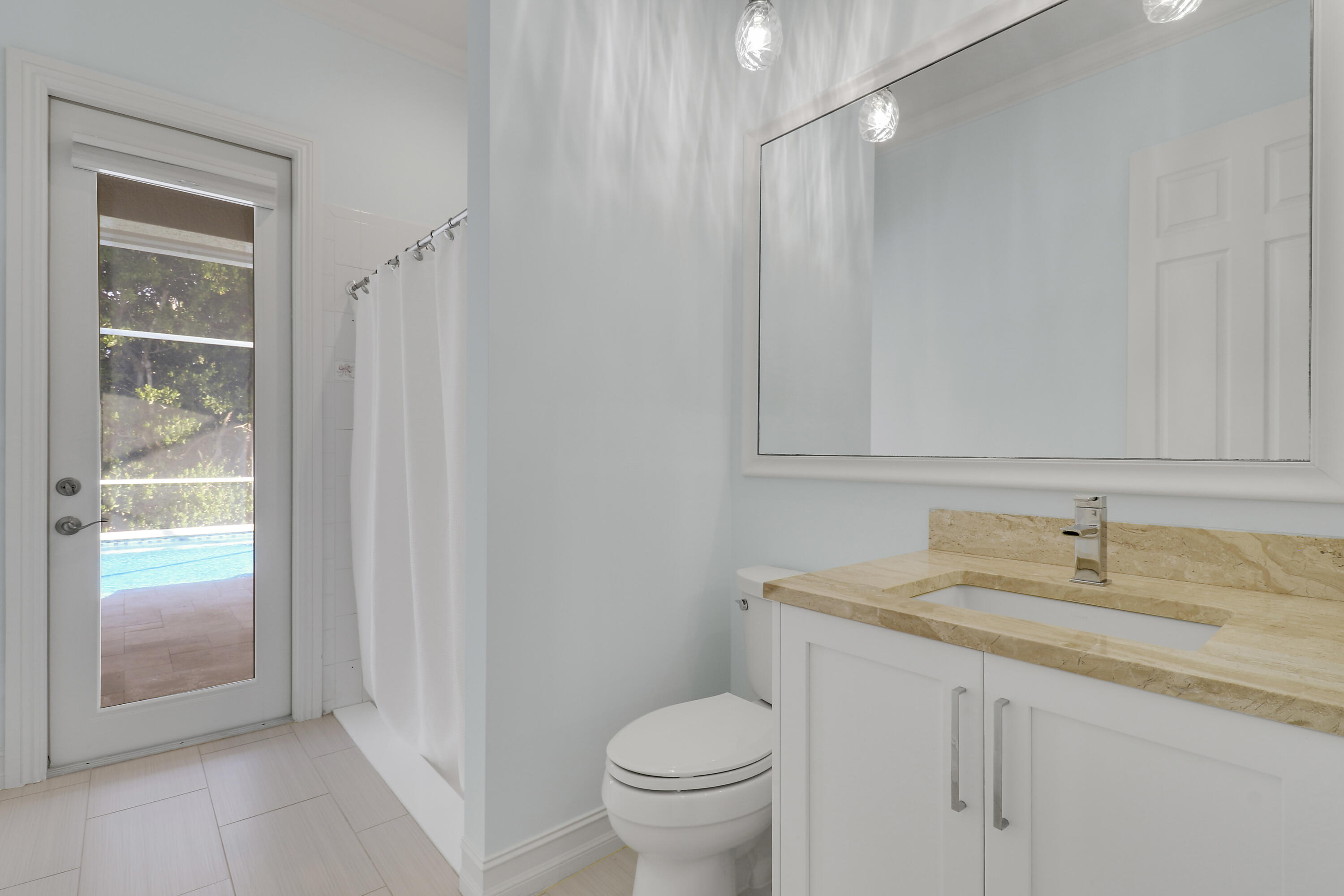8415 Southeast Governors Way Hobe Sound, FL 33455 - Photo 35 of 105 a bathroom with a granite countertop sink toilet and shower