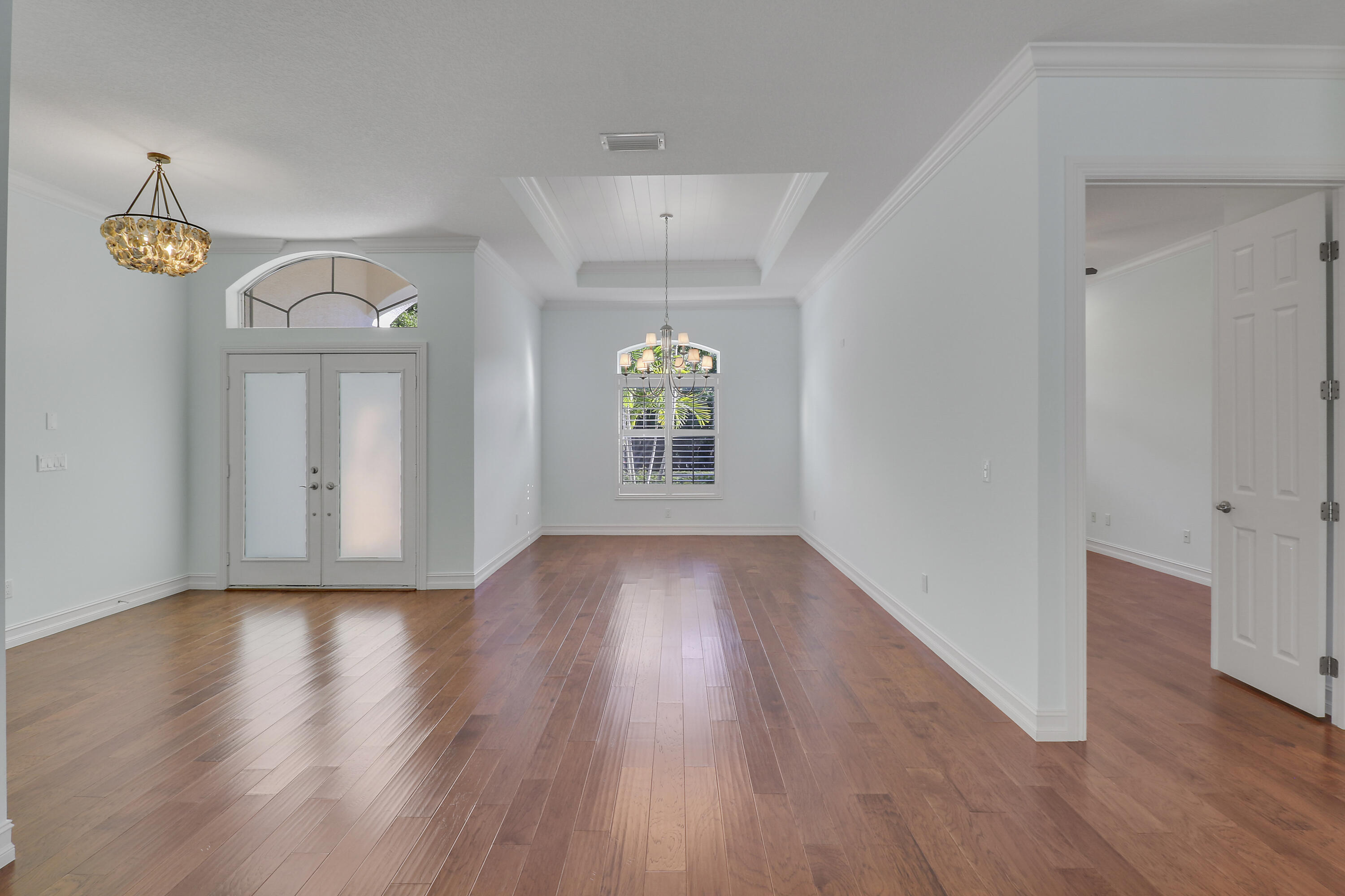 8415 Southeast Governors Way Hobe Sound, FL 33455 - Photo 45 of 105 a view of an empty room with wooden floor and a window