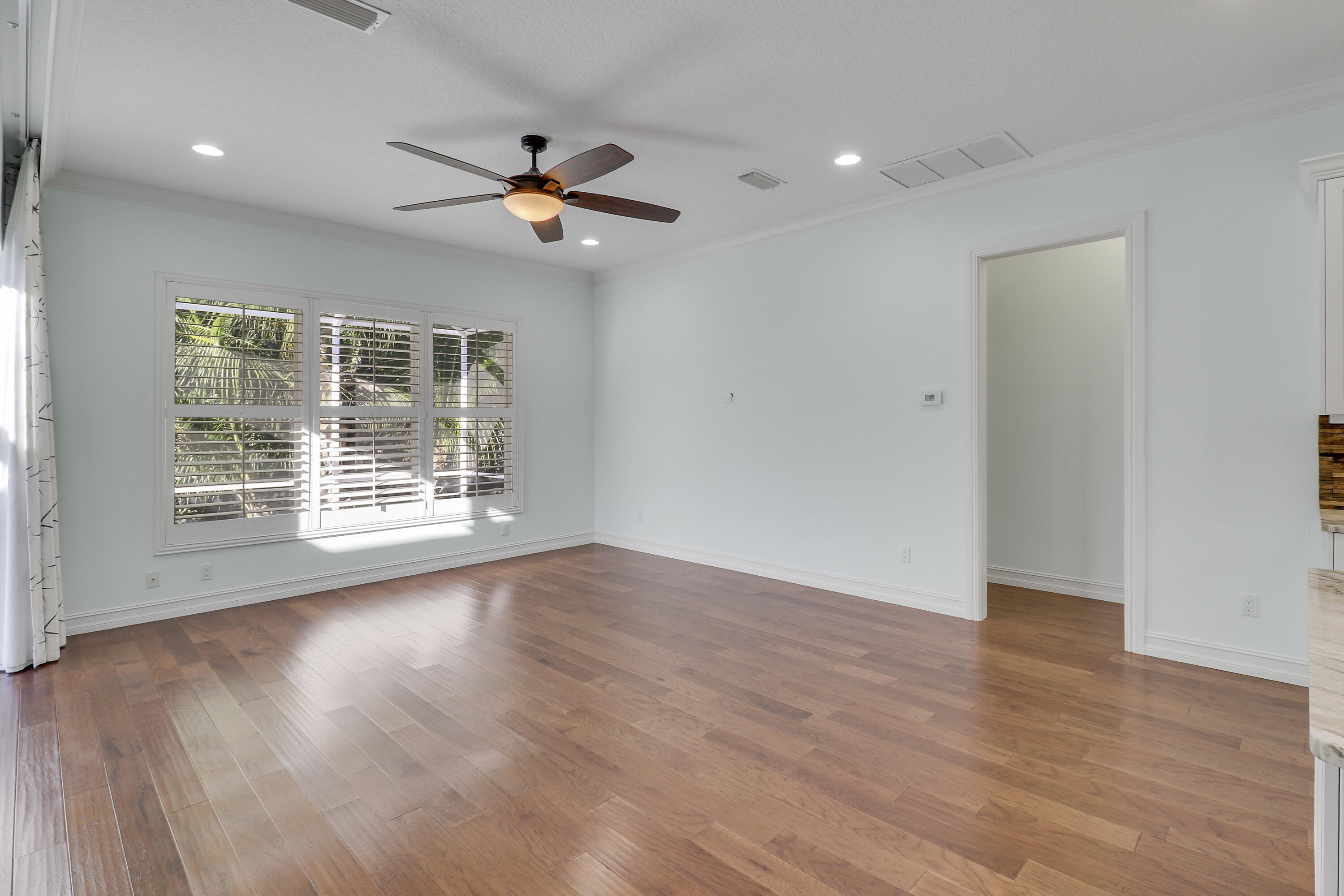 8415 Southeast Governors Way Hobe Sound, FL 33455 - Photo 53 of 105 a view of an empty room with wooden floor and a window