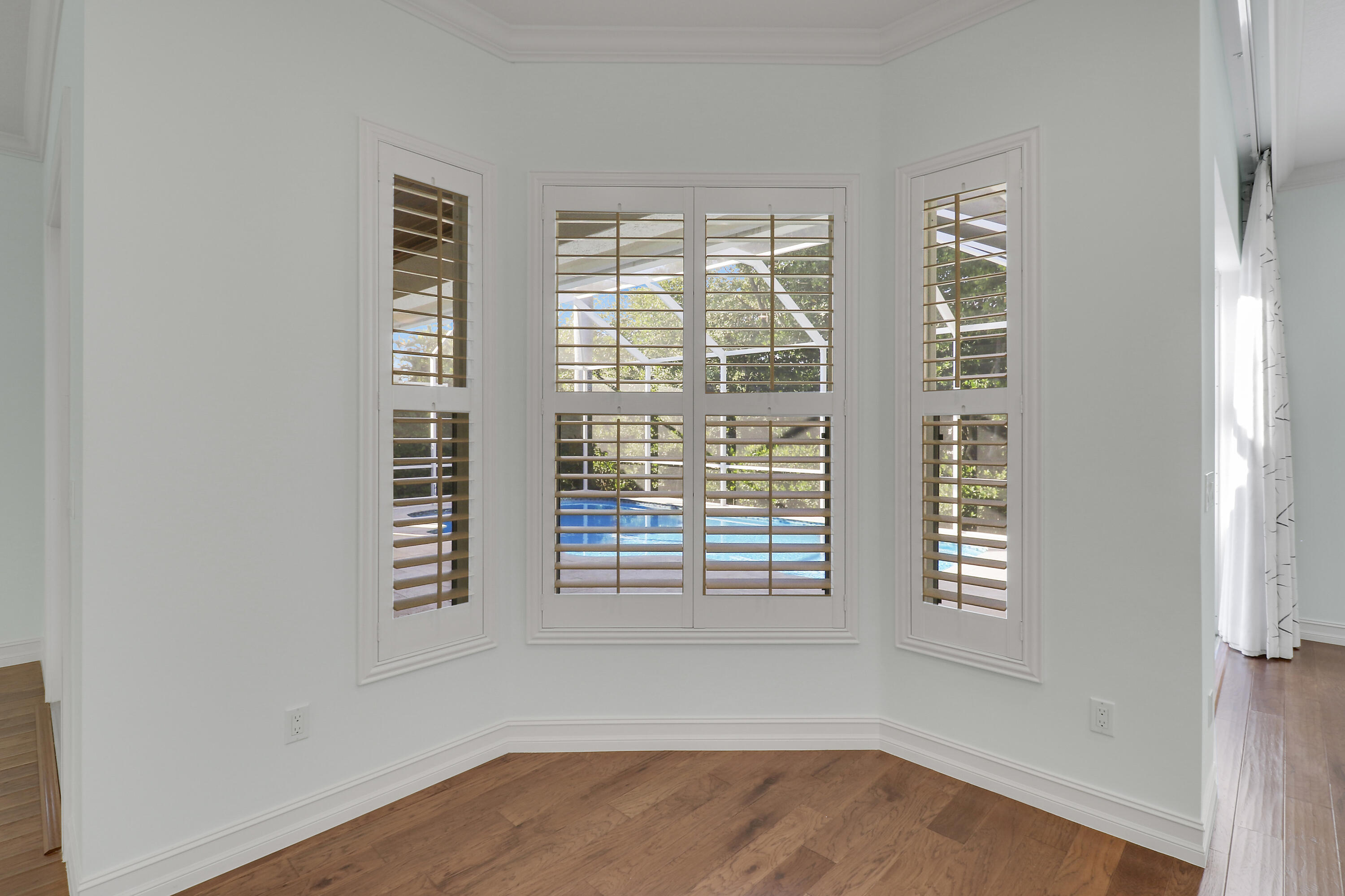 8415 Southeast Governors Way Hobe Sound, FL 33455 - Photo 55 of 105 a view of an empty room with wooden floor and a window