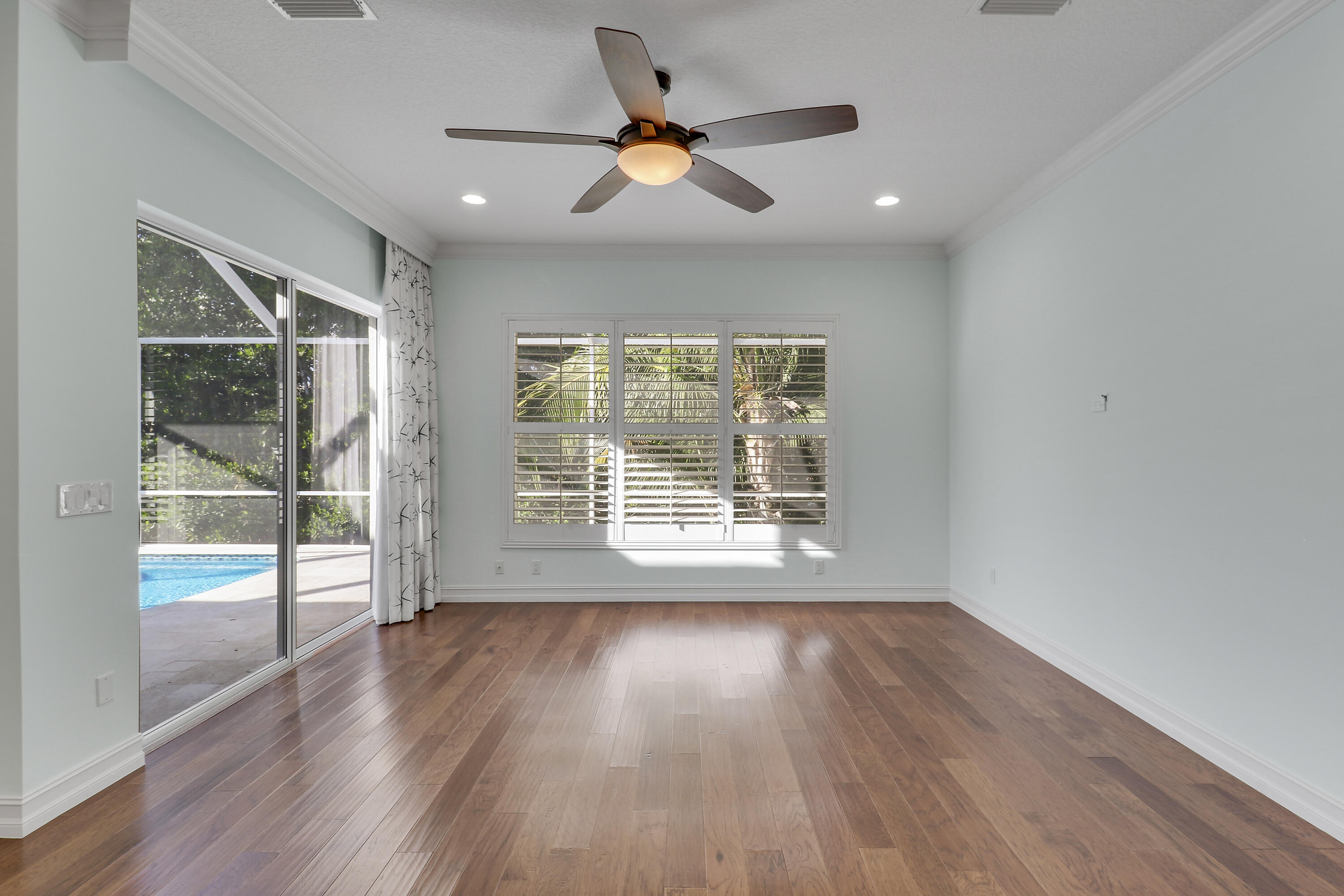 8415 Southeast Governors Way Hobe Sound, FL 33455 - Photo 57 of 105 a view of empty room with wooden floor and fan