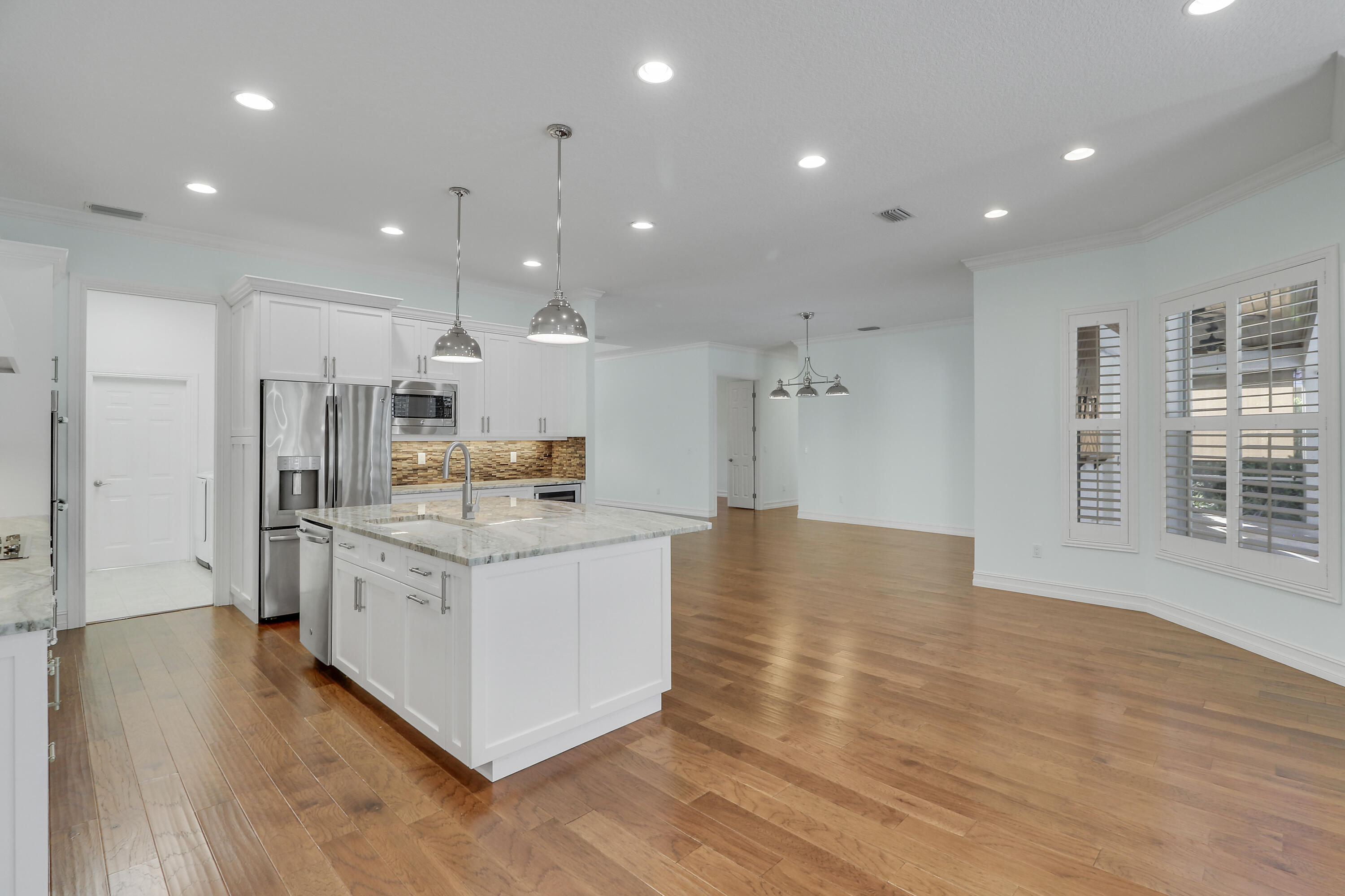 8415 Southeast Governors Way Hobe Sound, FL 33455 - Photo 61 of 105 a kitchen with stainless steel appliances kitchen island granite countertop a stove and a refrigerator
