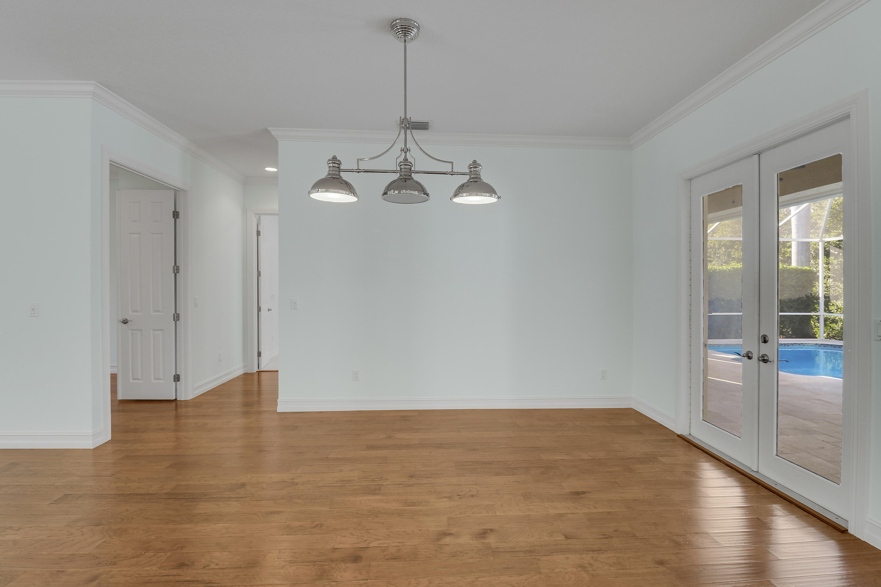 8415 Southeast Governors Way Hobe Sound, FL 33455 - Photo 66 of 105 a view of a room with wooden floor and white walls