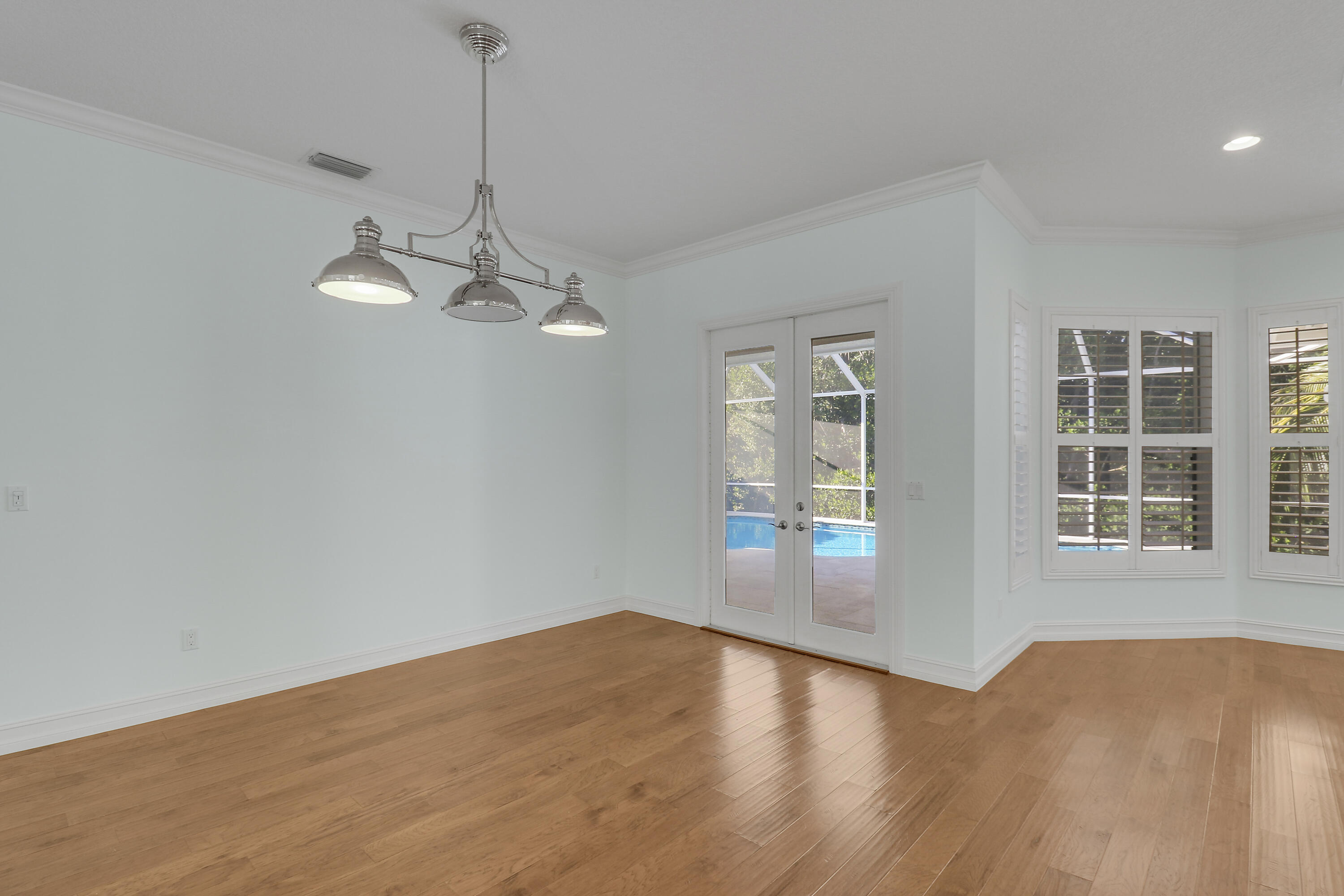 8415 Southeast Governors Way Hobe Sound, FL 33455 - Photo 67 of 105 a view of empty room with wooden floor and fan