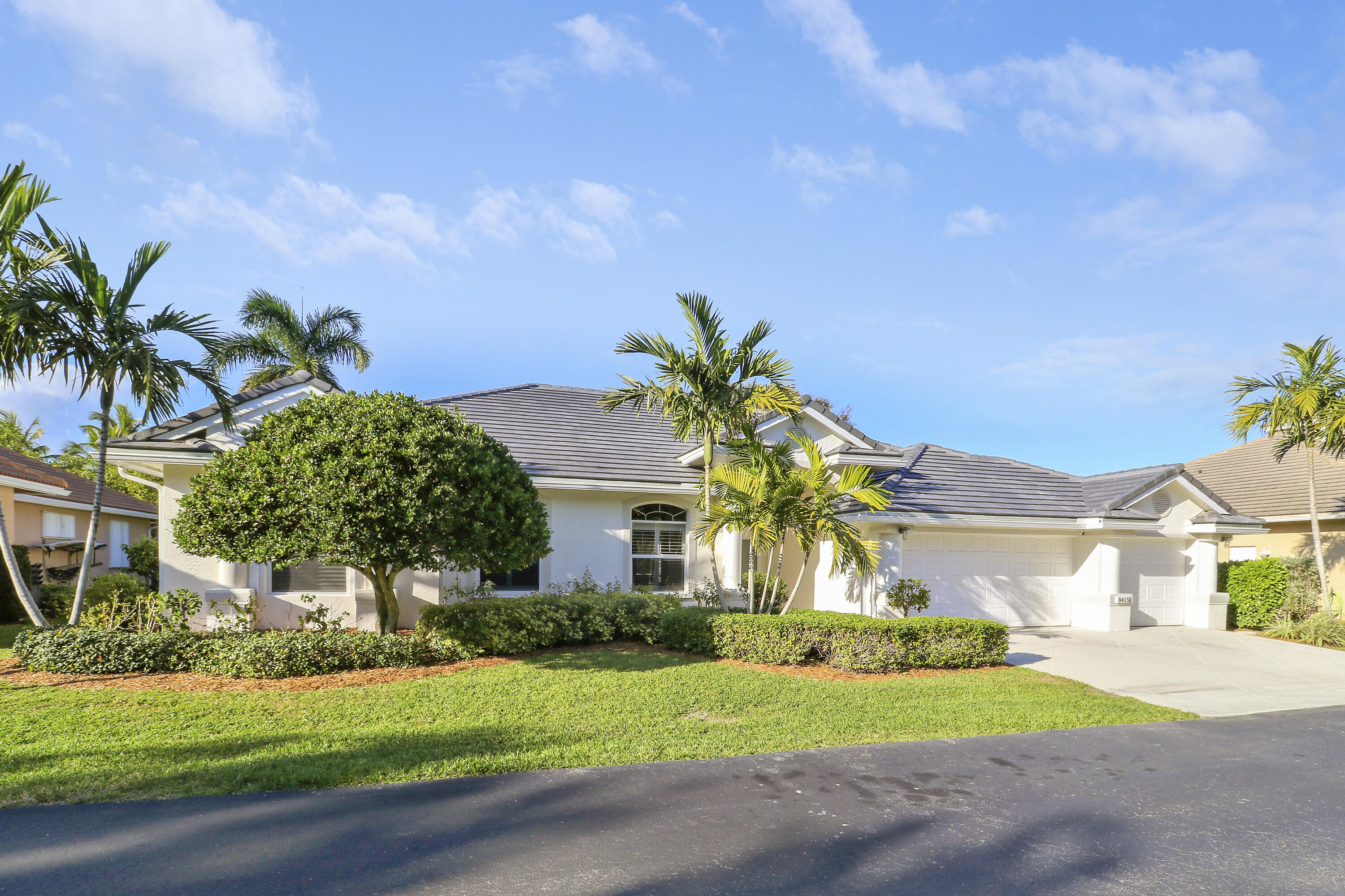 8415 Southeast Governors Way Hobe Sound, FL 33455 - Photo 79 of 105 a front view of a house with a yard and garage