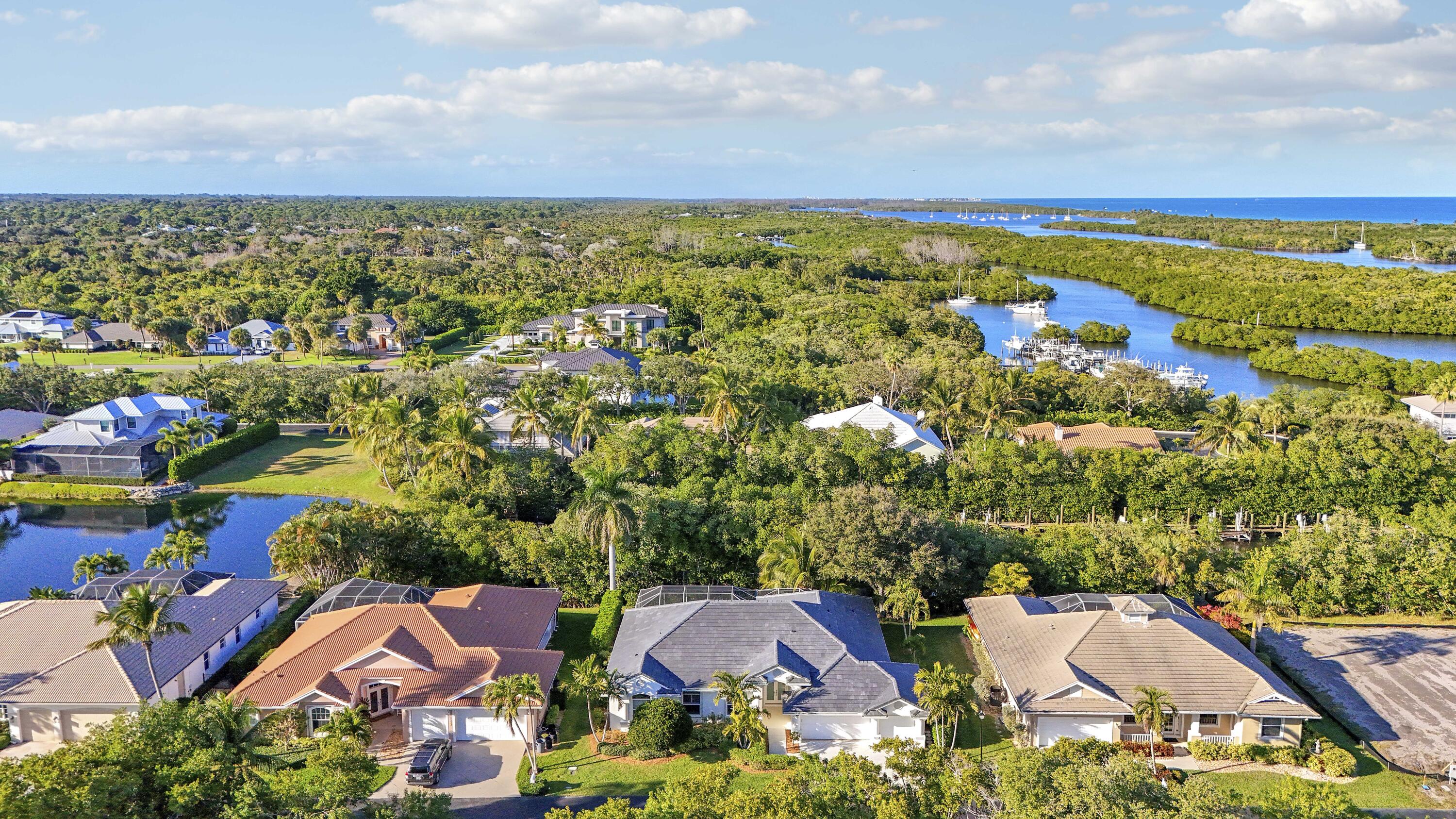 8415 Southeast Governors Way Hobe Sound, FL 33455 - Photo 84 of 105 an aerial view of residential houses with outdoor space and trees