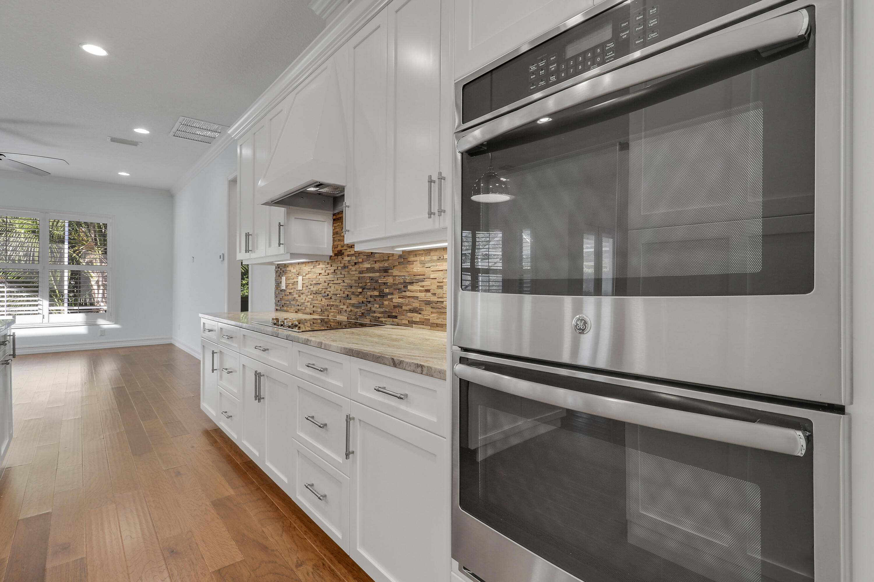 8415 Southeast Governors Way Hobe Sound, FL 33455 - Photo 10 of 105 a kitchen with granite countertop white cabinets and white appliances