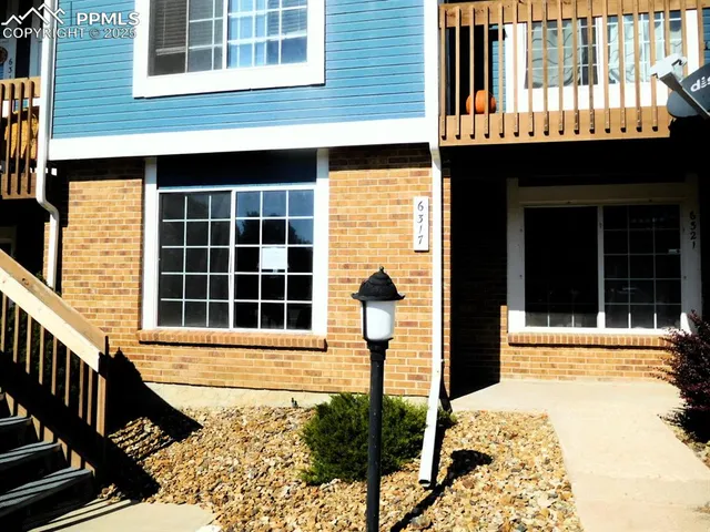 a front view of a house with a large window
