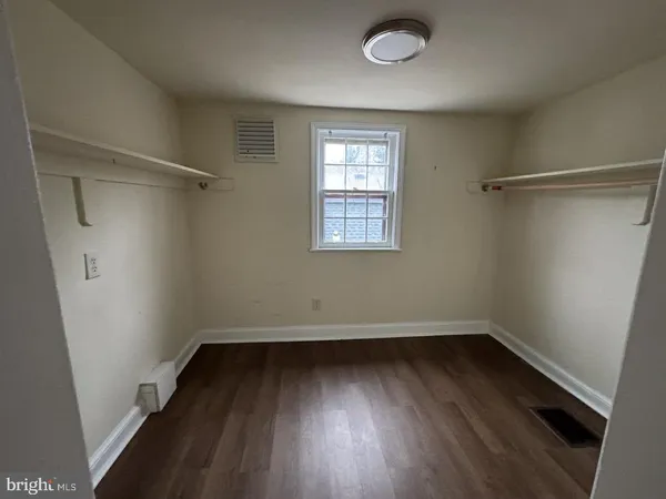 a view of a room with wooden floors and window