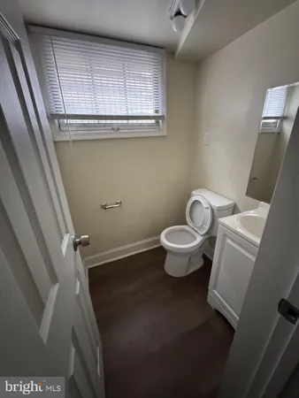 a bathroom with a toilet and a window