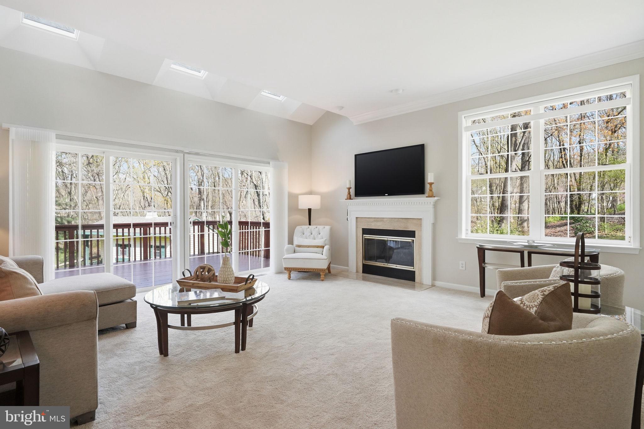520 Sunset Hollow Road West Chester, PA 19380 - Photo 25 of 68 a living room with furniture a fireplace and a flat screen tv