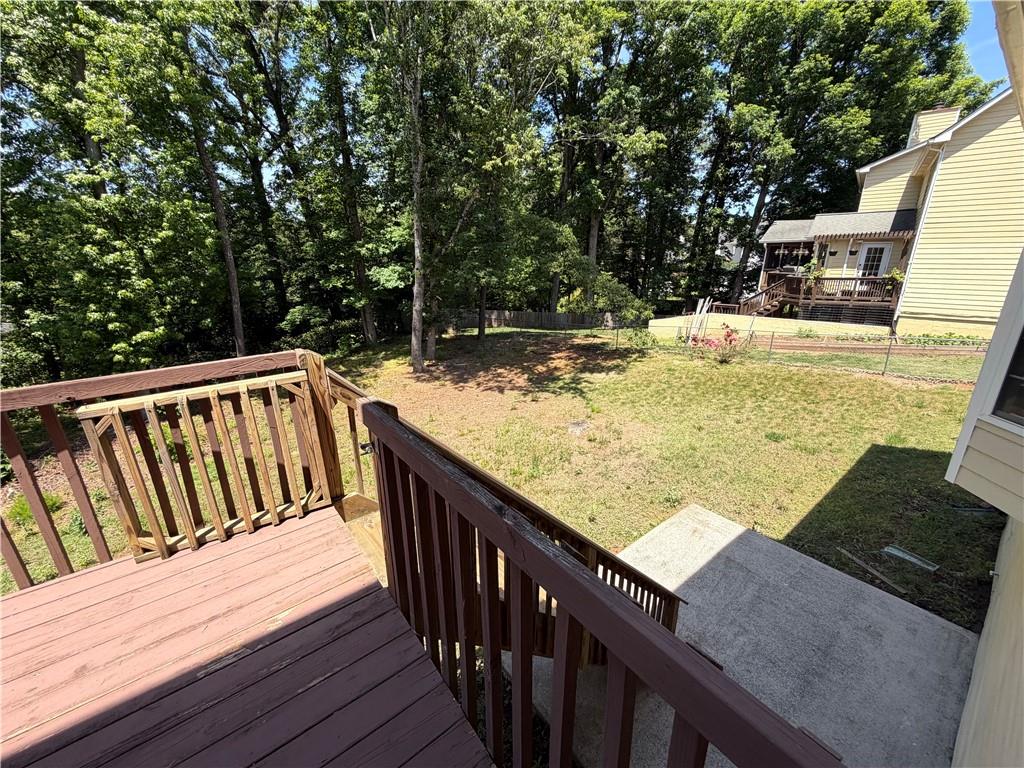 2205 Springer Walk Lawrenceville, GA 30043 - Photo 23 of 26 a view of a balcony with wooden floor and fence