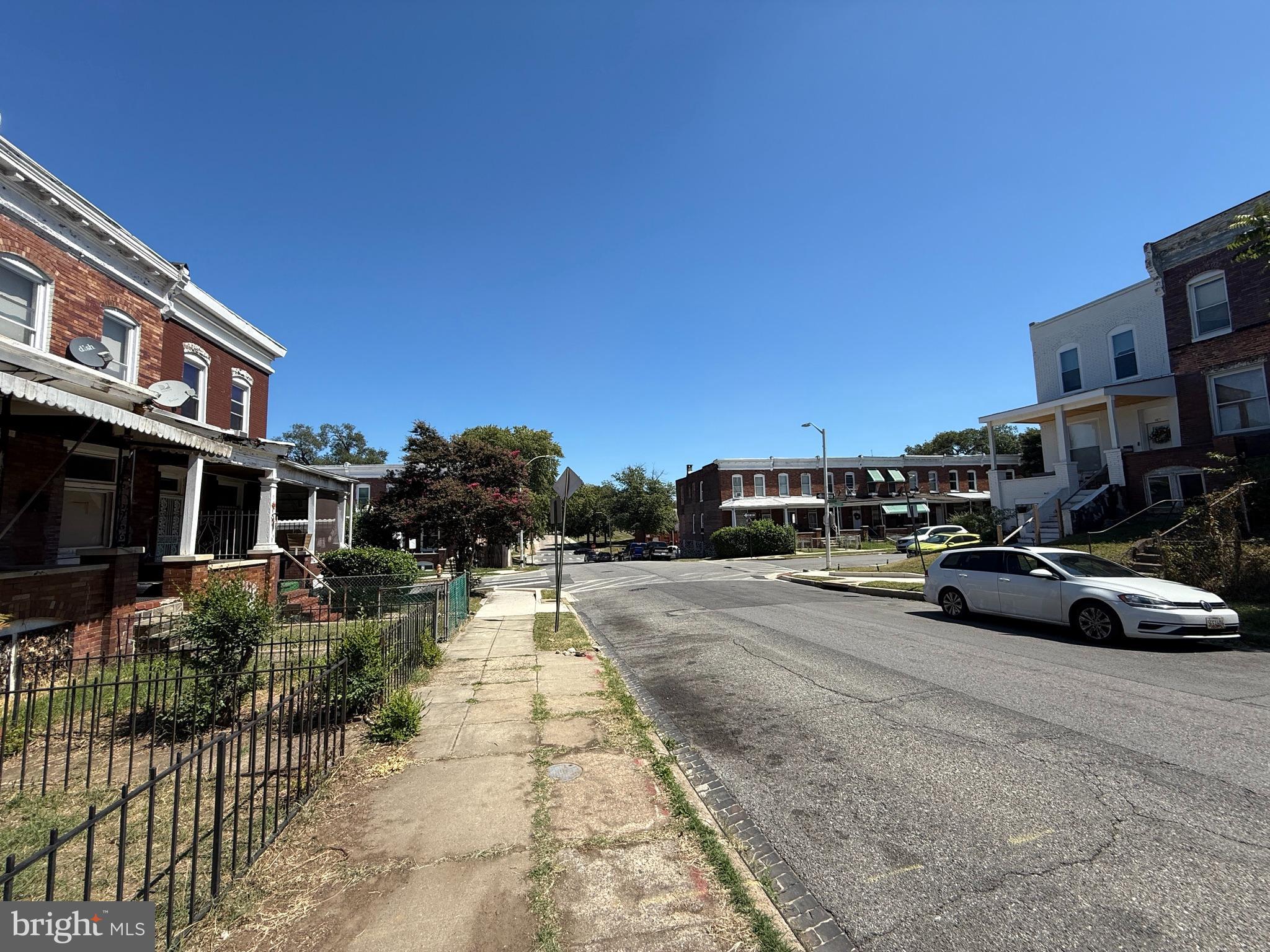 2706 Winchester Street Baltimore, MD 21216 - Photo 16 of 16 a view of multiple houses with a yard