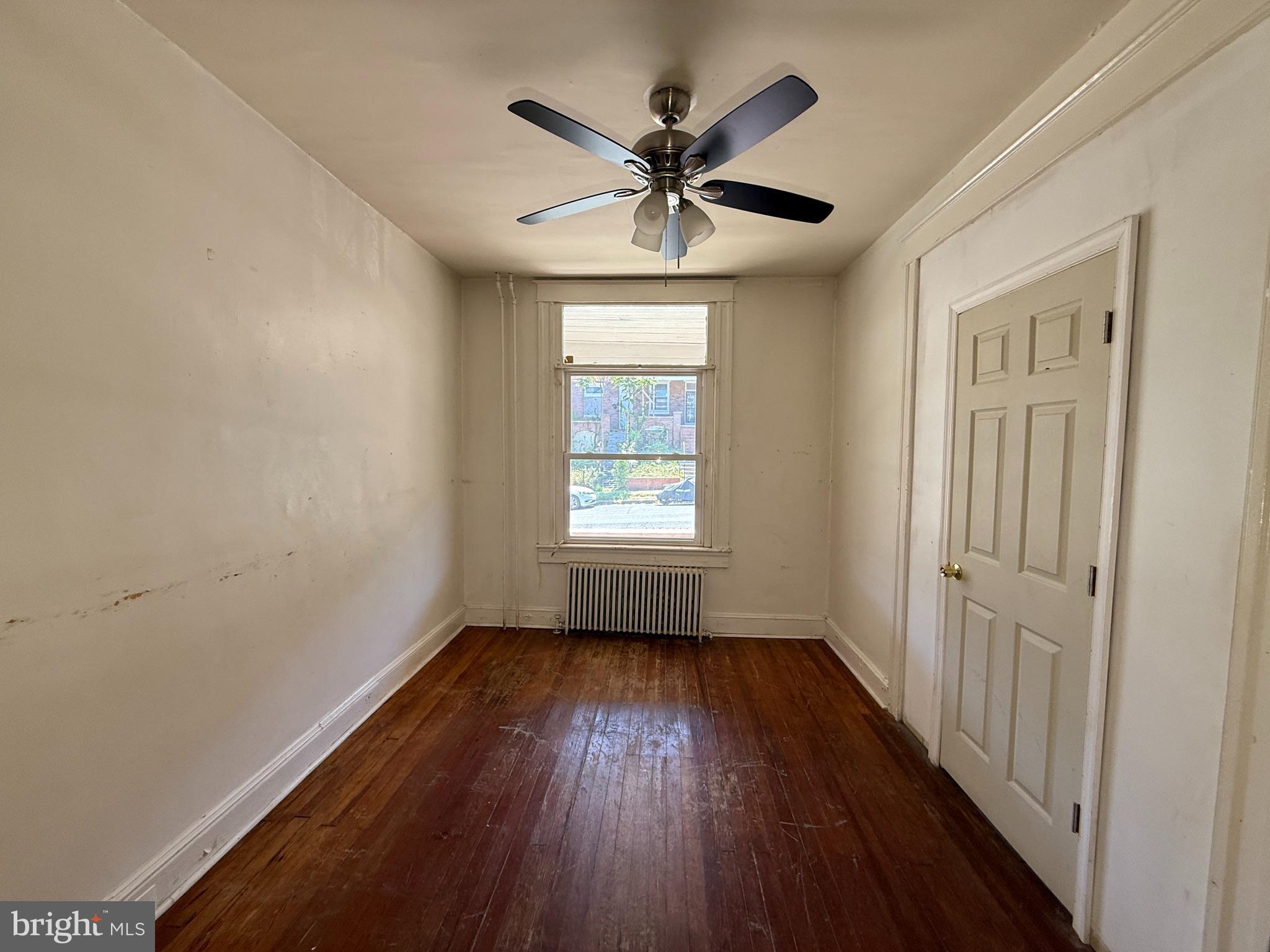 2706 Winchester Street Baltimore, MD 21216 - Photo 3 of 16 a view of empty room with wooden floor and fan