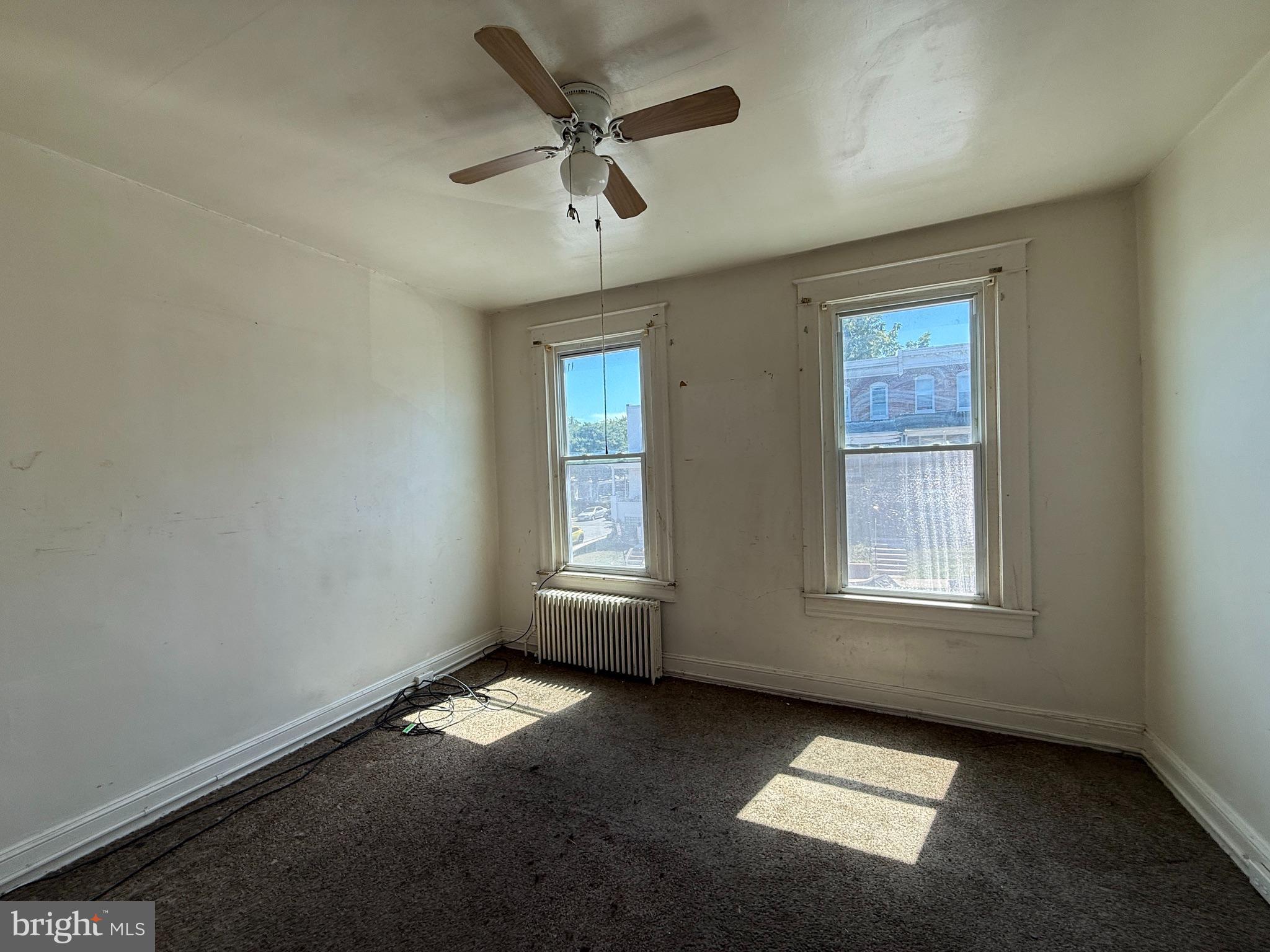 2706 Winchester Street Baltimore, MD 21216 - Photo 6 of 16 an empty room with a window and a ceiling fan
