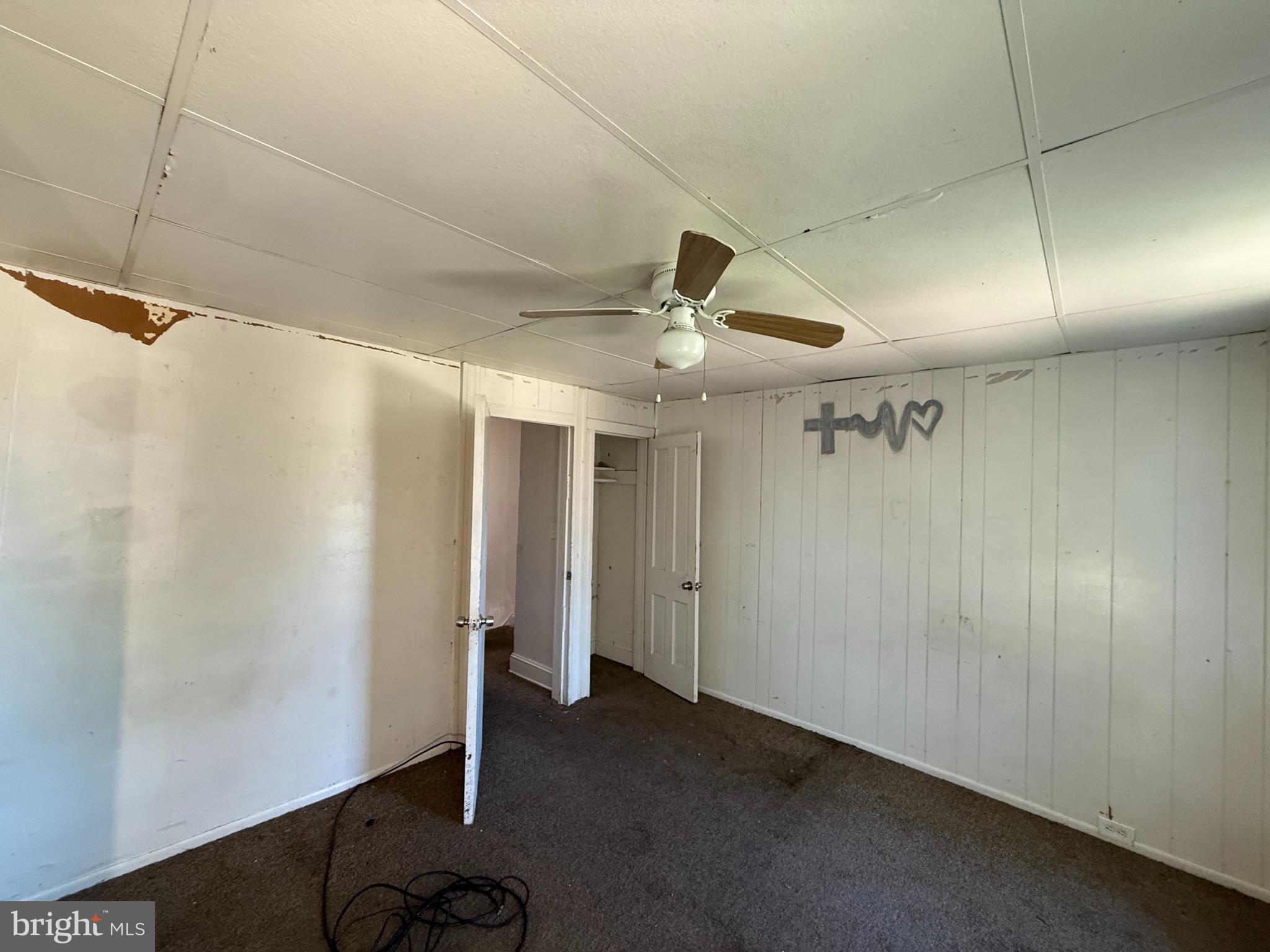 2706 Winchester Street Baltimore, MD 21216 - Photo 8 of 16 a view of a livingroom with a ceiling fan & dryer