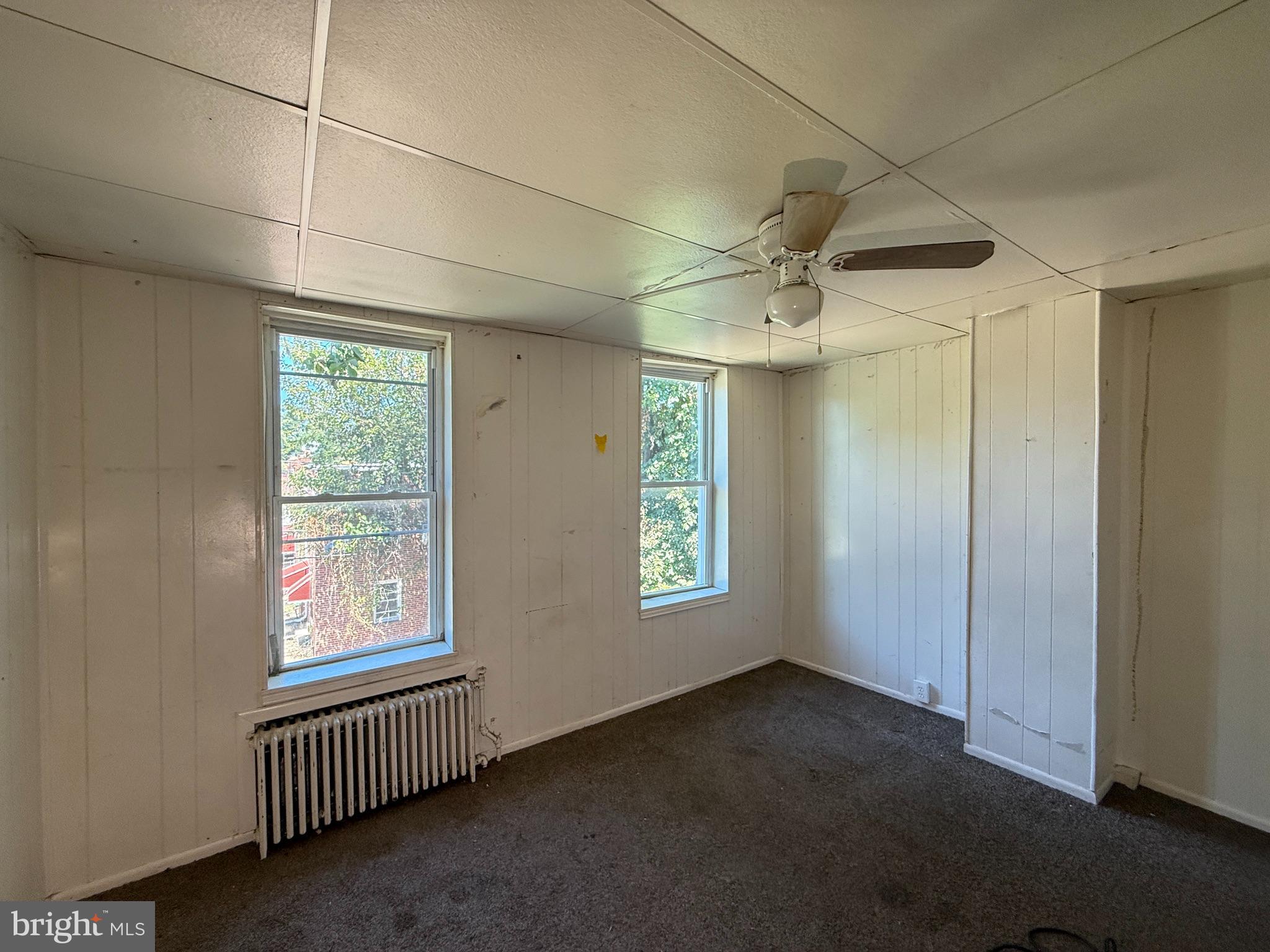 2706 Winchester Street Baltimore, MD 21216 - Photo 9 of 16 an empty room with windows and fan