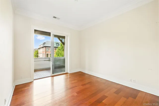 a view of a room with wooden floor