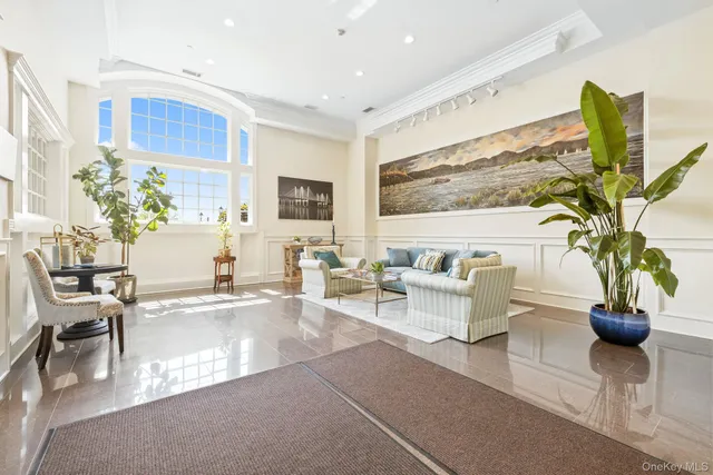 a hallway with wooden floor and a potted plant