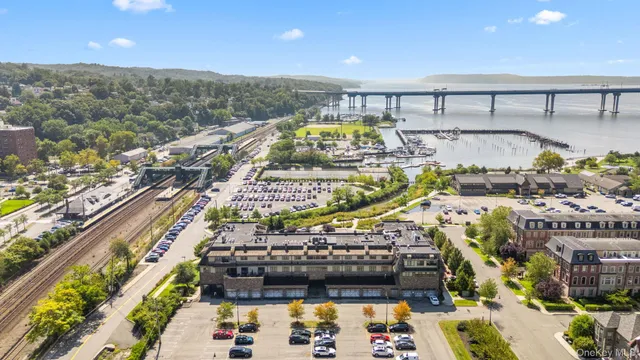 a view of a balcony with chairs and a potted plant