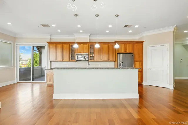 a view of a kitchen and a chandelier fan