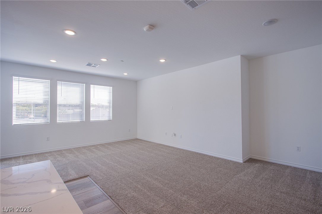 2555 Hampton Road, Unit 8201 Henderson, NV 89052 - Photo 27 of 33 Recessed lighting and wall-to-wall carpeting define this versatile, open living area.