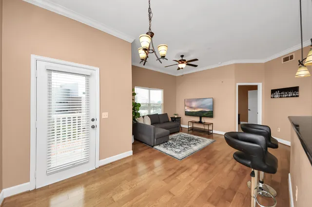 a kitchen with stainless steel appliances kitchen island granite countertop a refrigerator a stove a sink and a granite counter tops