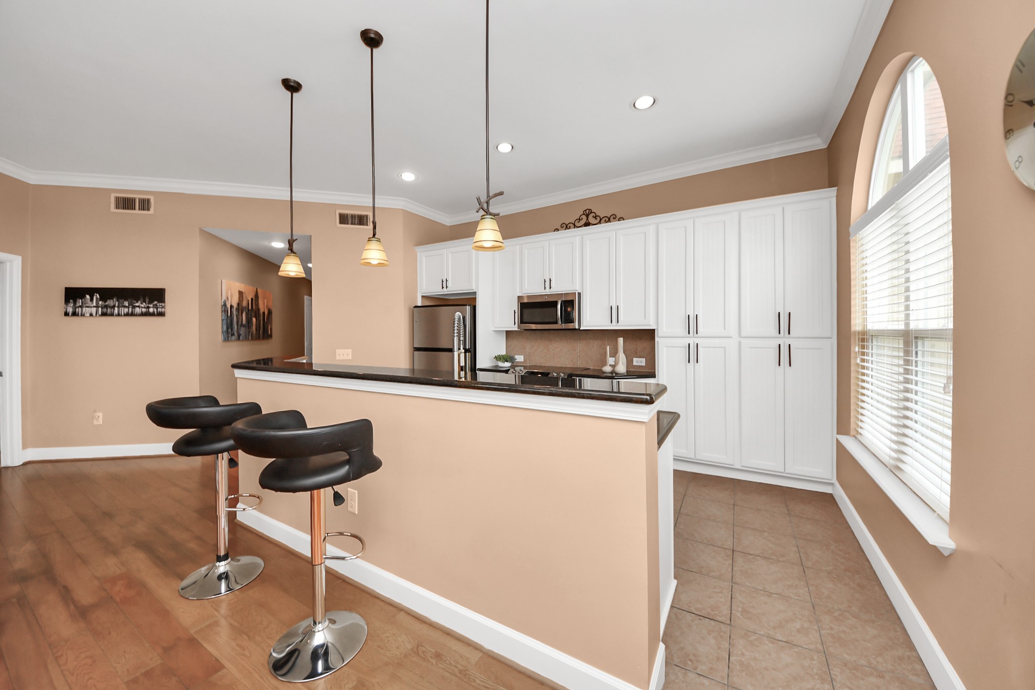 2203 Dorrington Street, Unit 400 Houston, TX 77030 - Photo 14 of 43 a kitchen with stainless steel appliances kitchen island granite countertop a refrigerator a stove a sink and a granite counter tops