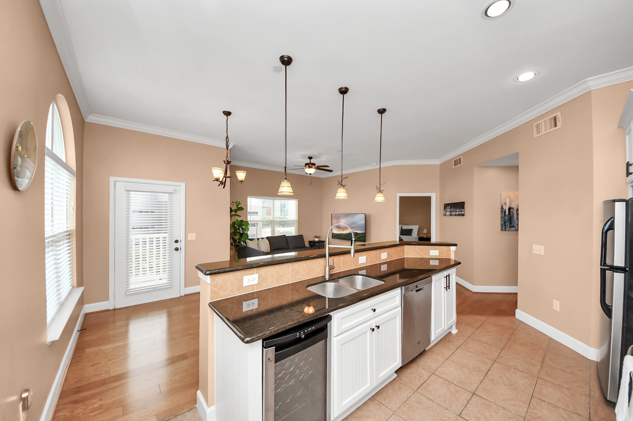 2203 Dorrington Street, Unit 400 Houston, TX 77030 - Photo 15 of 43 a kitchen with stainless steel appliances granite countertop a sink and a wooden floors