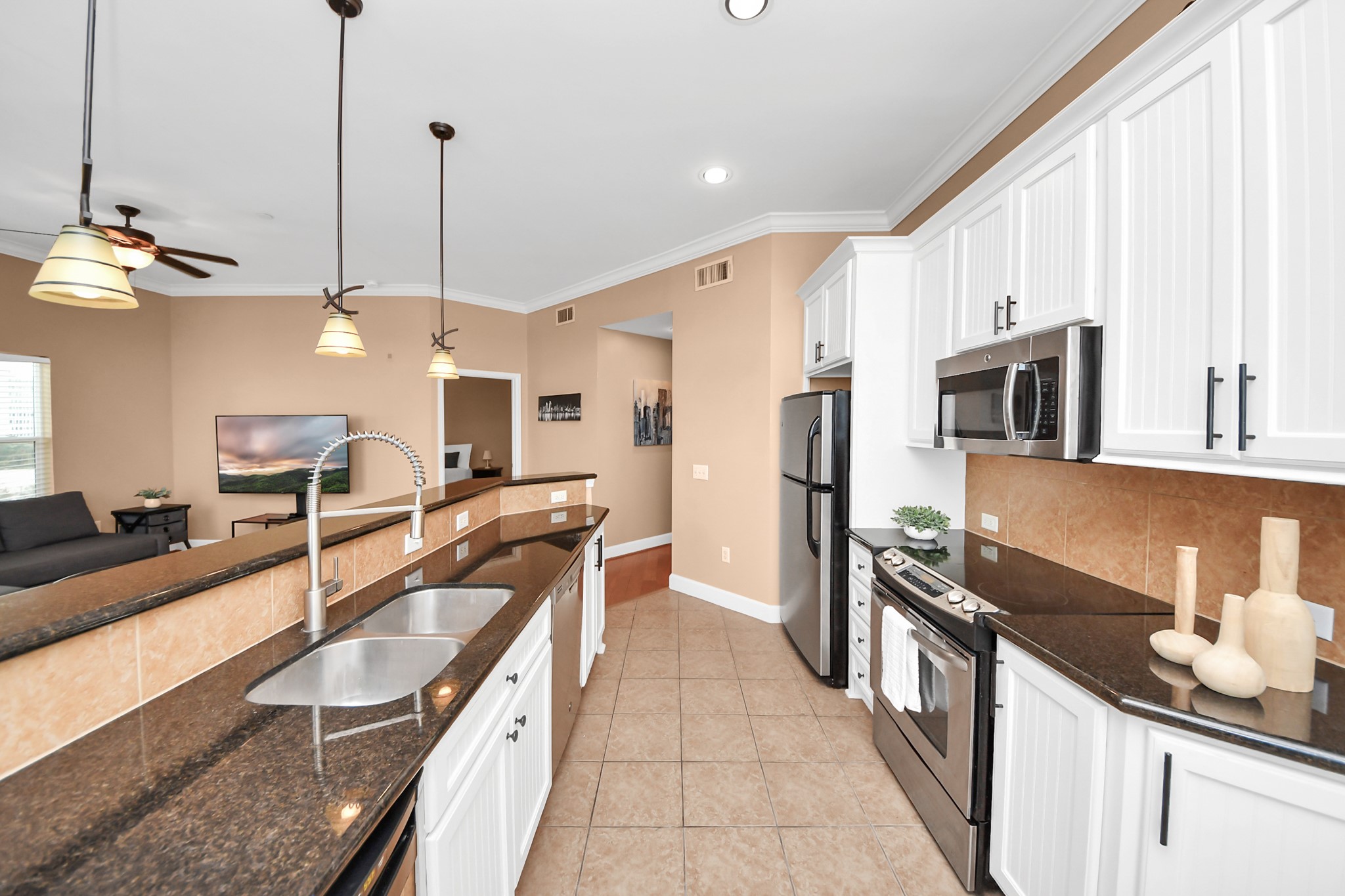 2203 Dorrington Street, Unit 400 Houston, TX 77030 - Photo 16 of 43 a kitchen with stainless steel appliances granite countertop a sink a stove and a refrigerator
