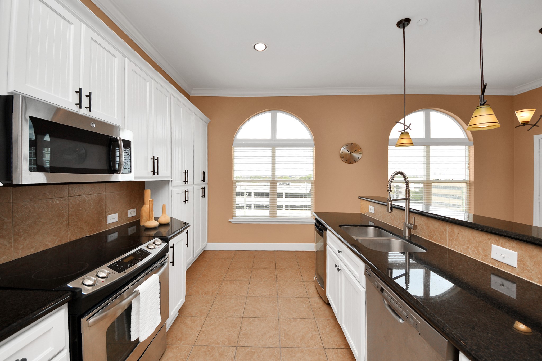 2203 Dorrington Street, Unit 400 Houston, TX 77030 - Photo 18 of 43 a kitchen with stainless steel appliances granite countertop a stove a sink and a microwave