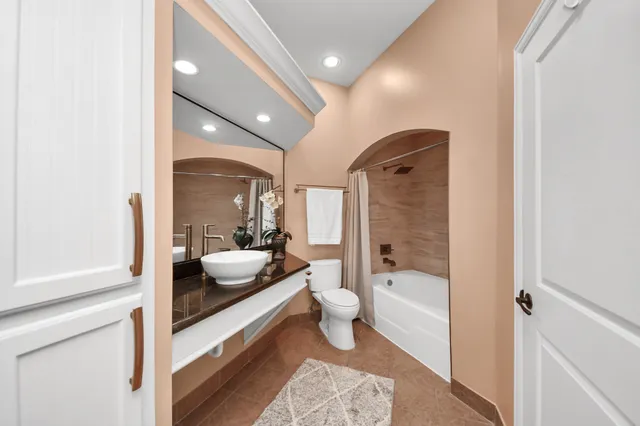 a bedroom with a bed and a ceiling fan