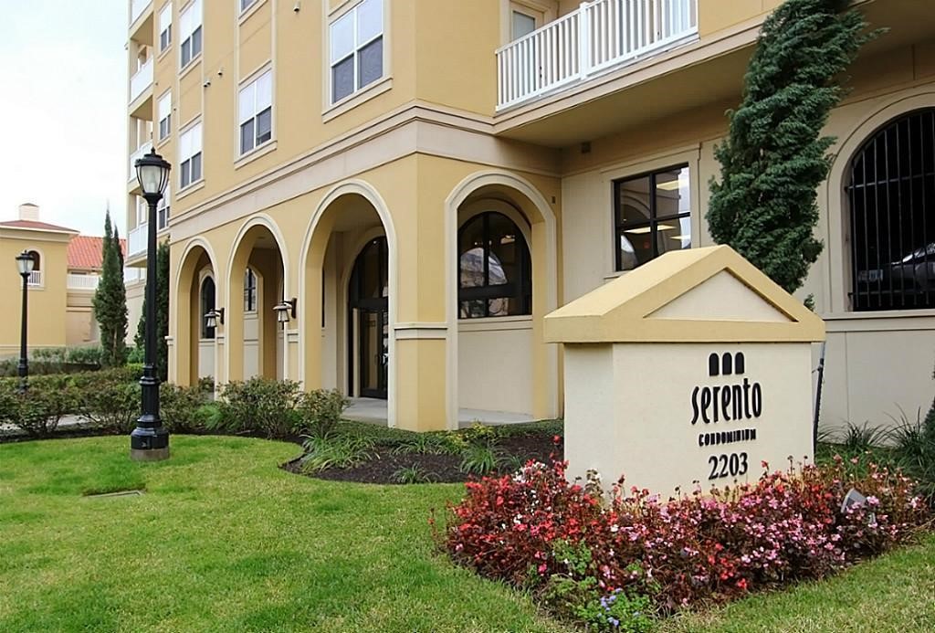 2203 Dorrington Street, Unit 400 Houston, TX 77030 - Photo 3 of 43 a front view of a house with a garden