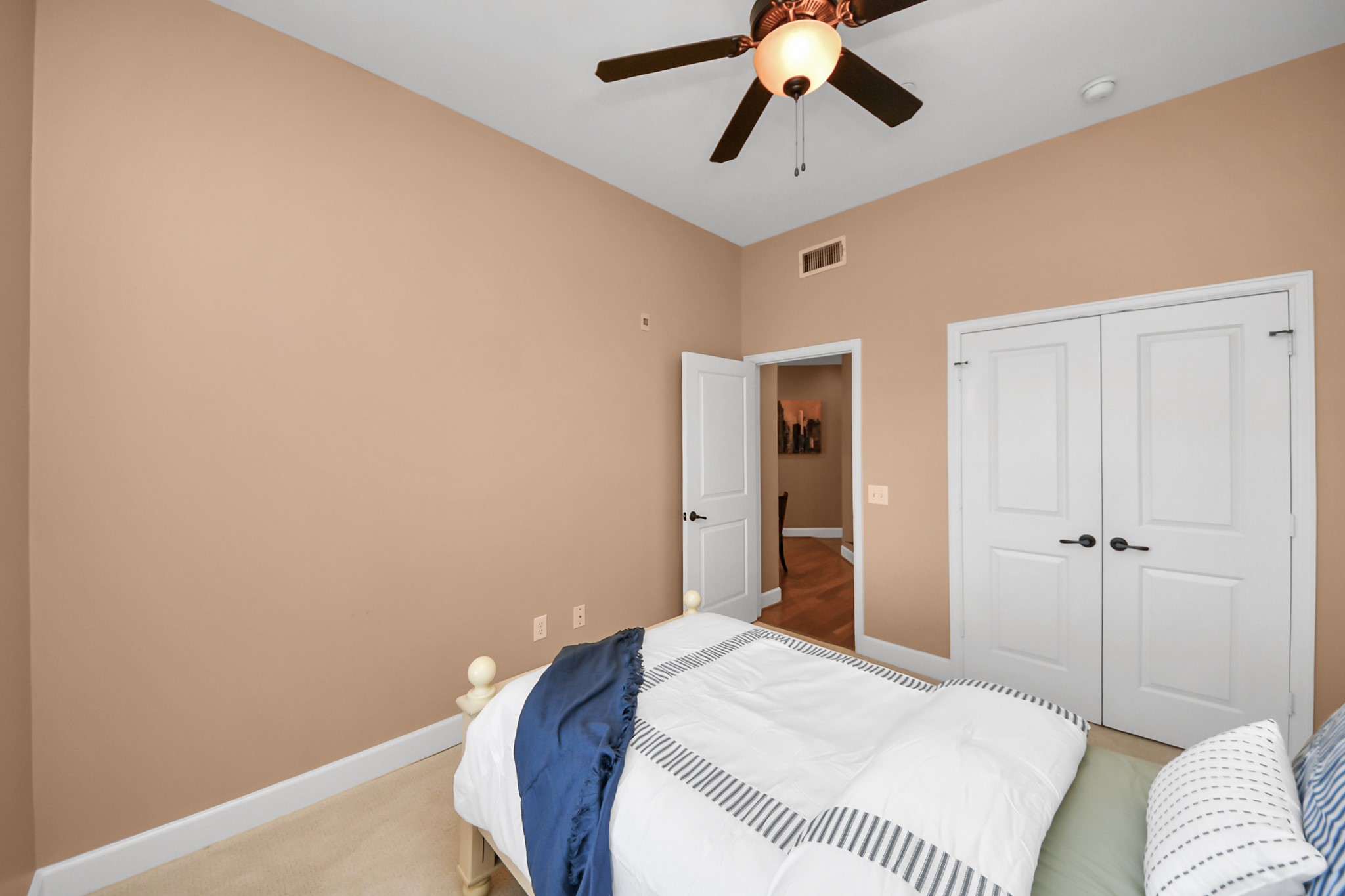 2203 Dorrington Street, Unit 400 Houston, TX 77030 - Photo 31 of 43 a bedroom with a bed and a chandelier