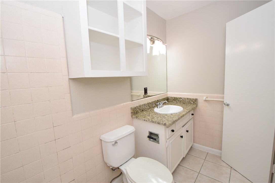 2404 Longview Street, Unit 103 Austin, TX 78705 - Photo 3 of 12 a bathroom with a granite countertop sink and a toilet