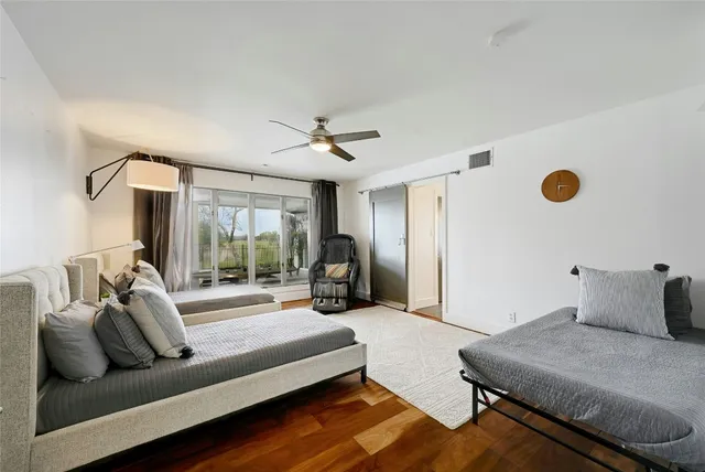 a bedroom with furniture and a large window