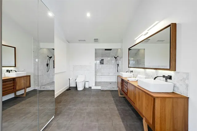 a spacious bathroom with a tub sink and mirror