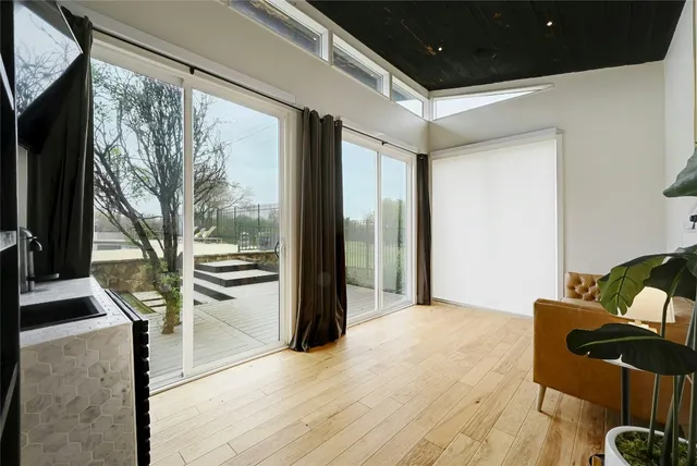 a living room with furniture and a floor to ceiling window