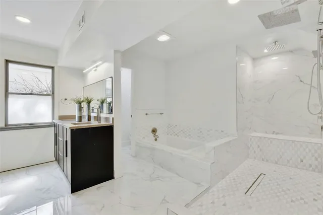 a bathroom with a bathtub and a sink