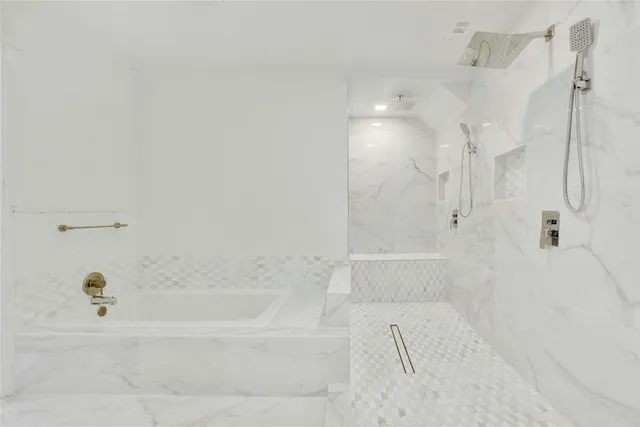 a bathroom with a bathtub and shower