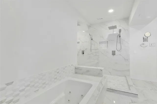 a bathroom with a bathtub and shower