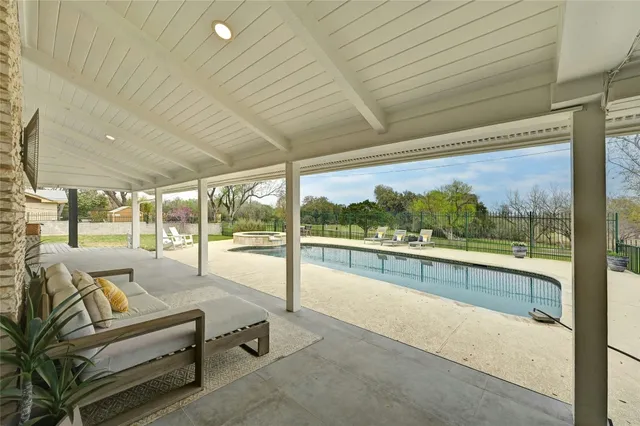 a view of a house with swimming pool and porch with furniture