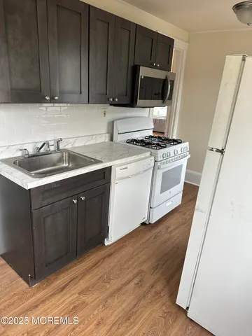 a kitchen with a sink and a microwave