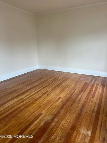 an empty room with wooden floor