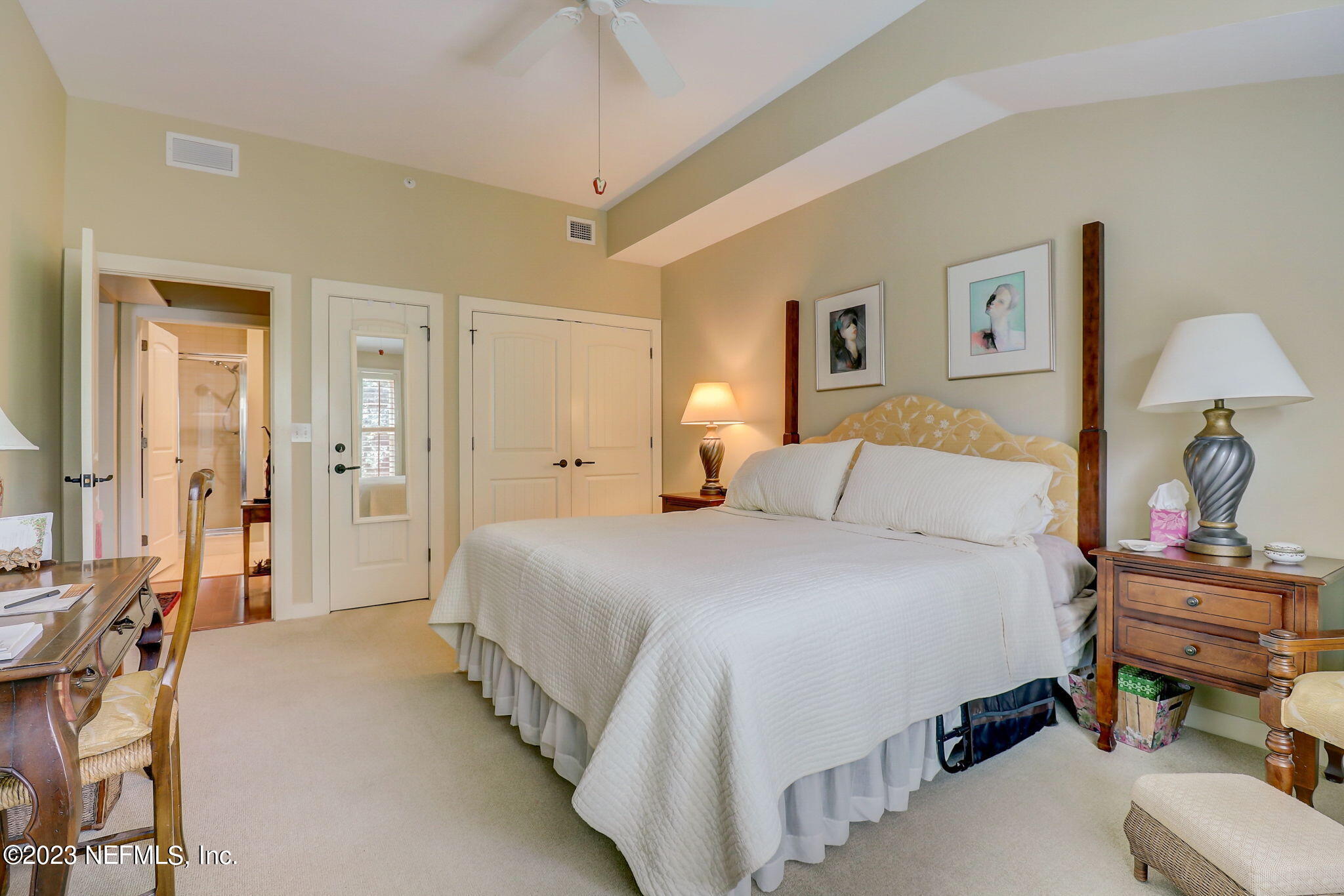 965 Registry Boulevard, Unit 307 St. Augustine, FL 32092 - Photo 12 of 31 a bed room with a bed and a lamp